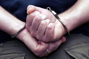 Arrested man wearing handcuffs - Nobody knows you fiction