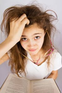 Frustrated woman reading - Mastering Your Mean Girl book review