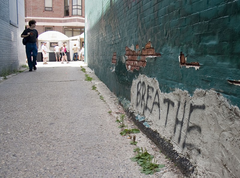 wall in alley with breathe grafitti