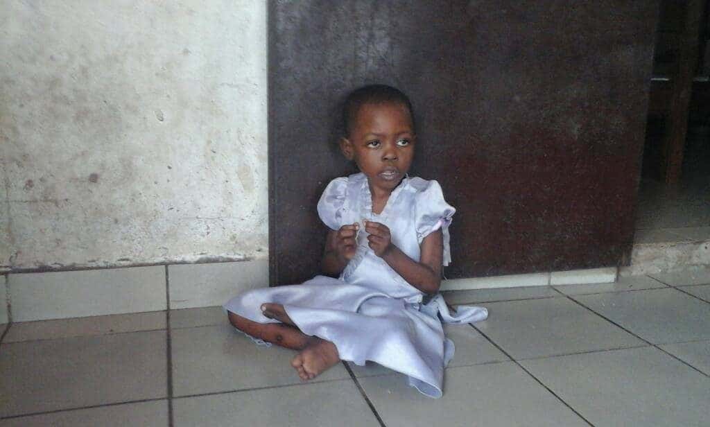 young girl sitting on floor