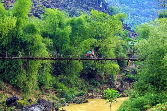 couple on motorbike on bridge in vietnam
