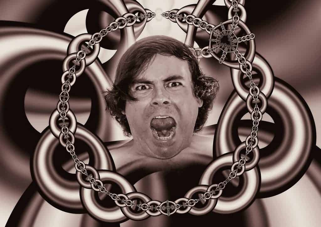 man's face surrounded by chains