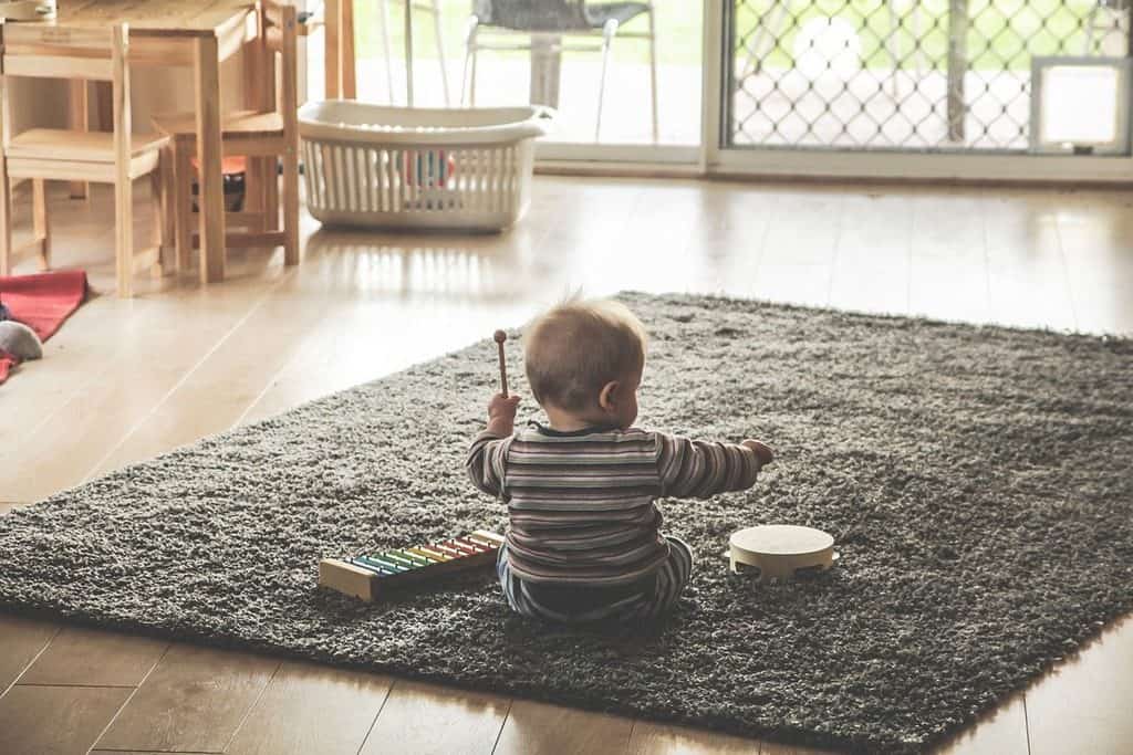 baby playing with toy instruments