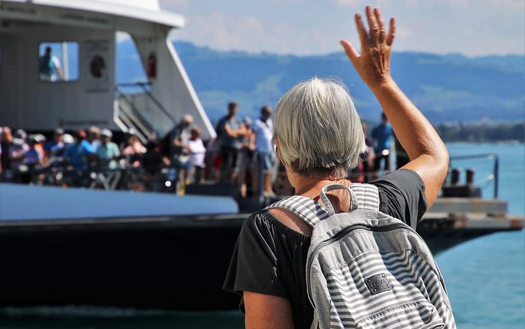 woman waving at seniors on a cruise shi[