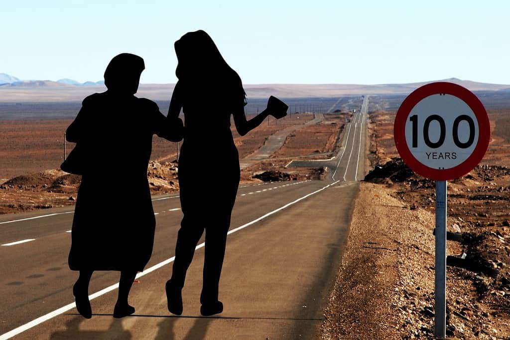 silhouette of young and older woman walking together