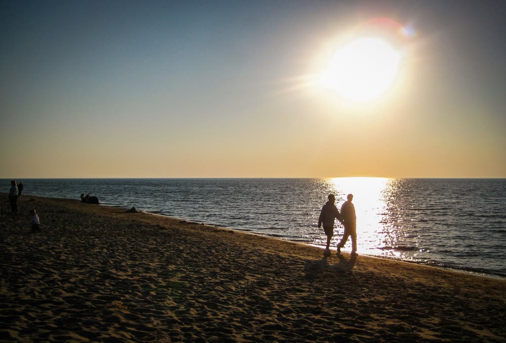 father and son walking on beach