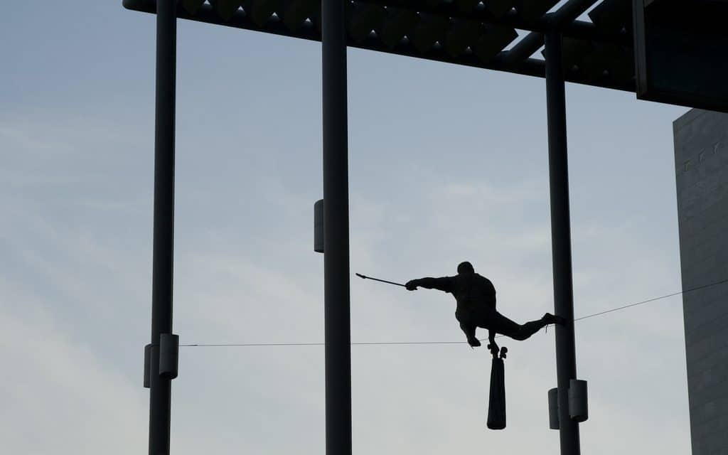 man walking tightrope