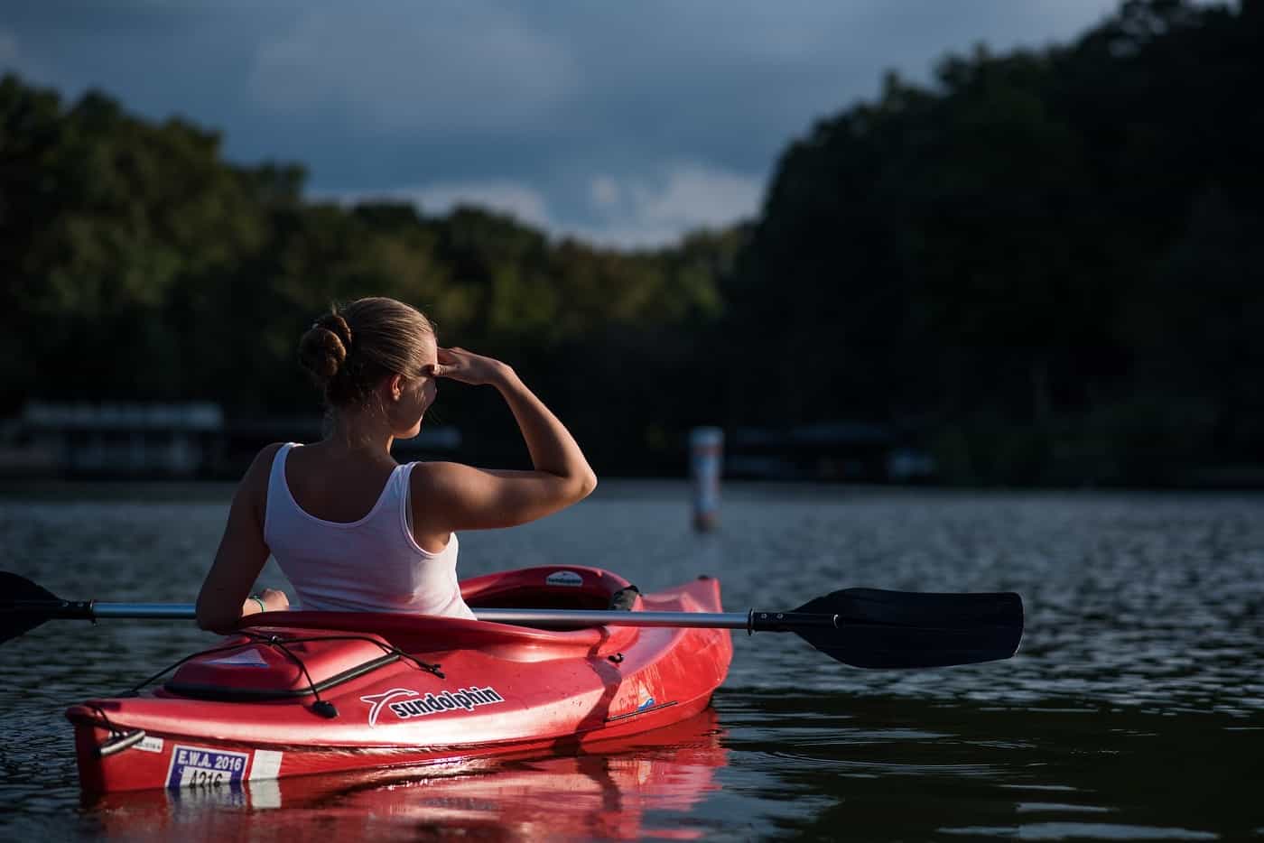 Woman paddling in sea kayak - Addiction treatment