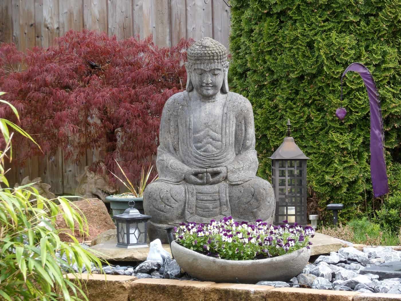 Buddha statue, lanterns and flowers outdoors - 4 basic stages of meditation