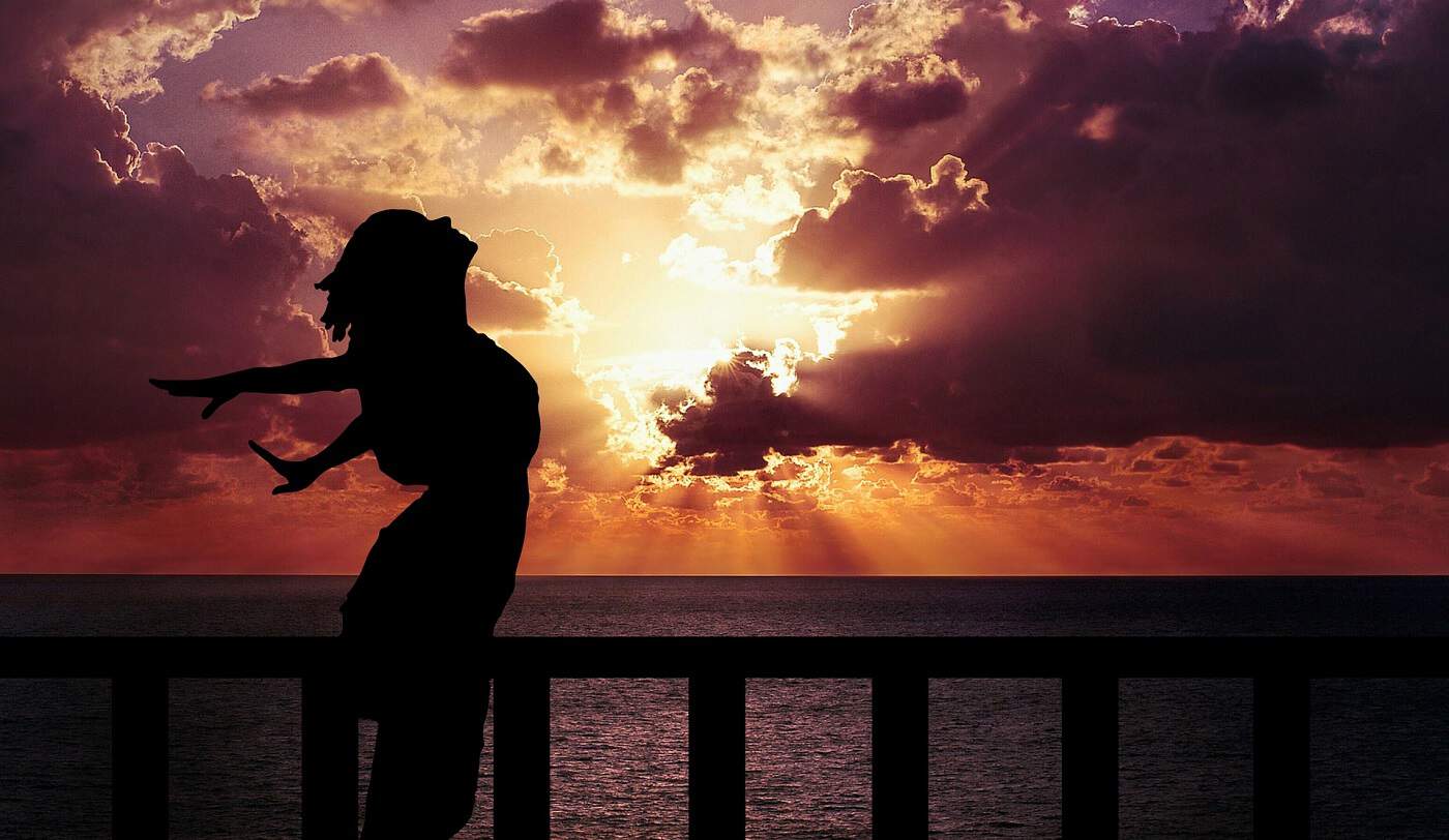 Silhouette of woman at sunset with arms outstretched, face to sky - Put on your oxygen mask
