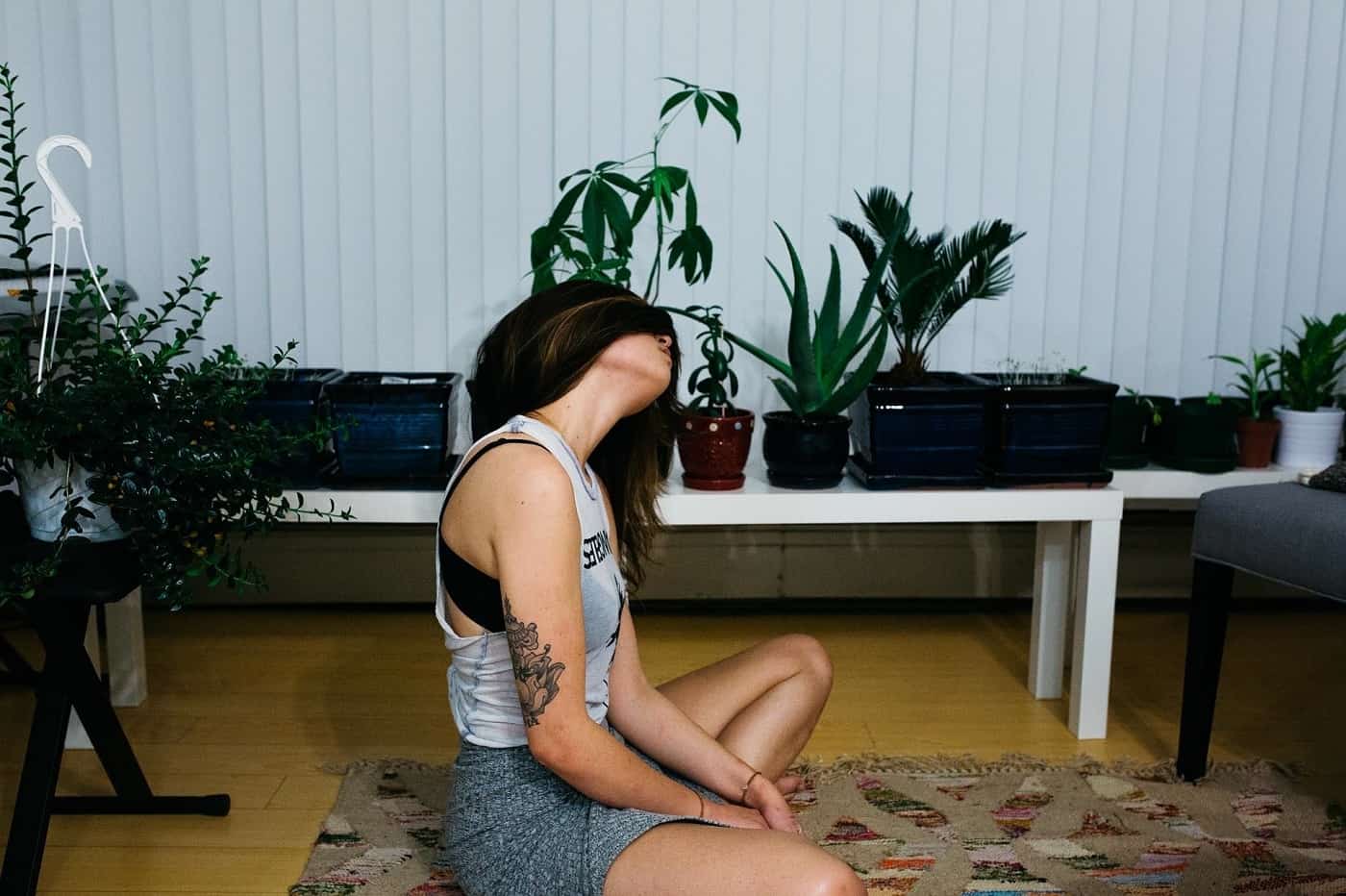 Young woman meditating on mat - Meditate on your pain