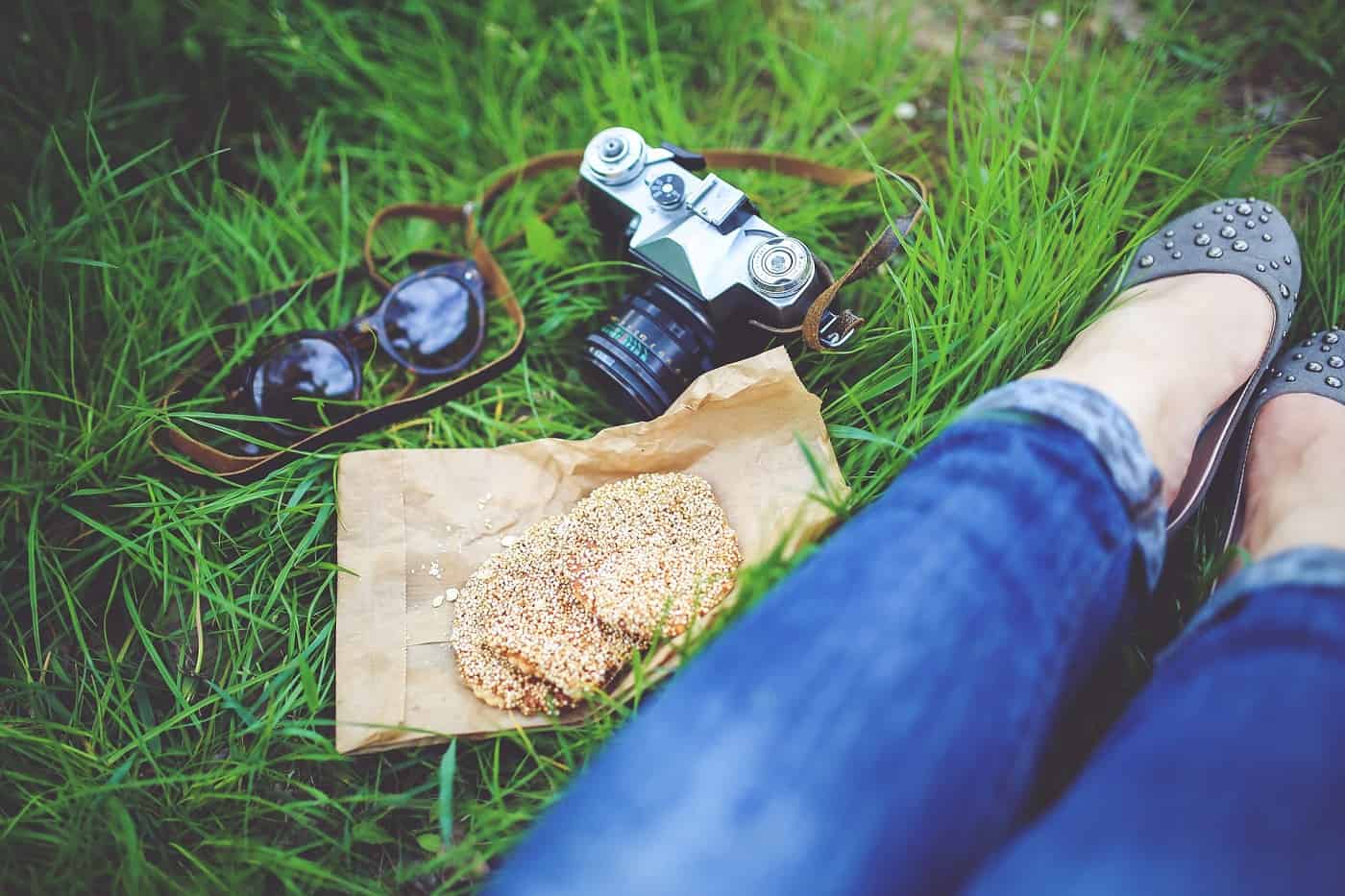 Woman sitting in grass next to two cookies - Self-trust and compassion