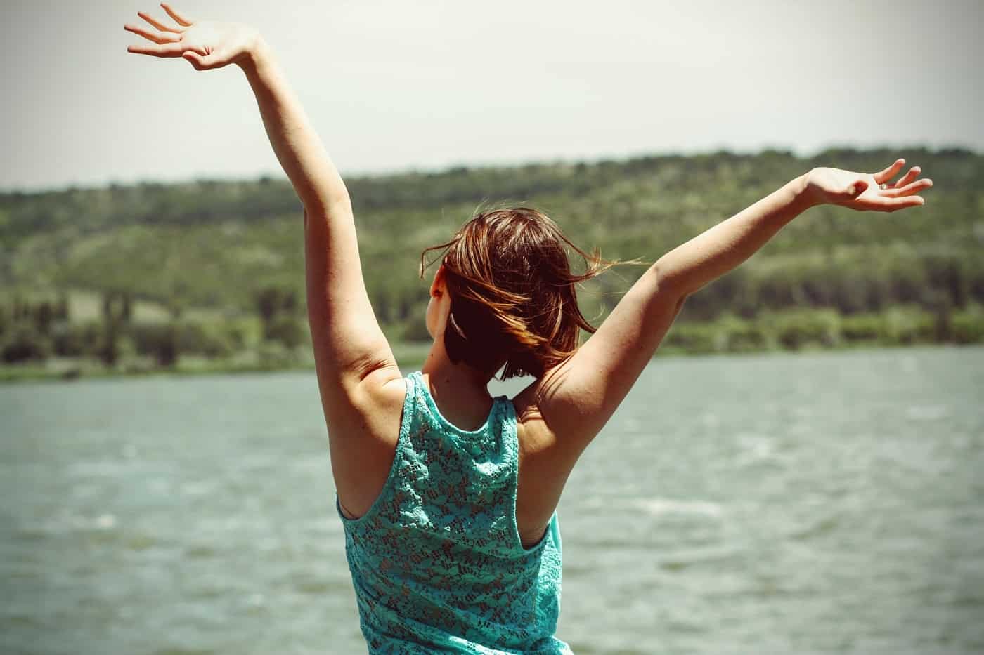 Joyful woman beside lake - Marie Kondo's tidying up
