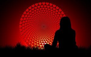 LOVE ON EVERY BREATH: A Tonglen meditation for transforming pain into joy 14 Woman meditating in front of wheel of hearts