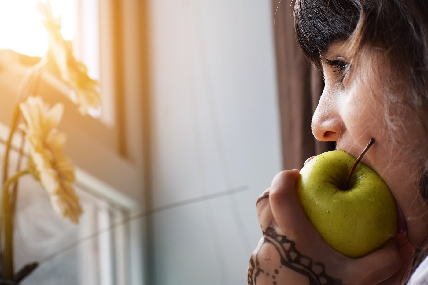 Woman taking bite of apple