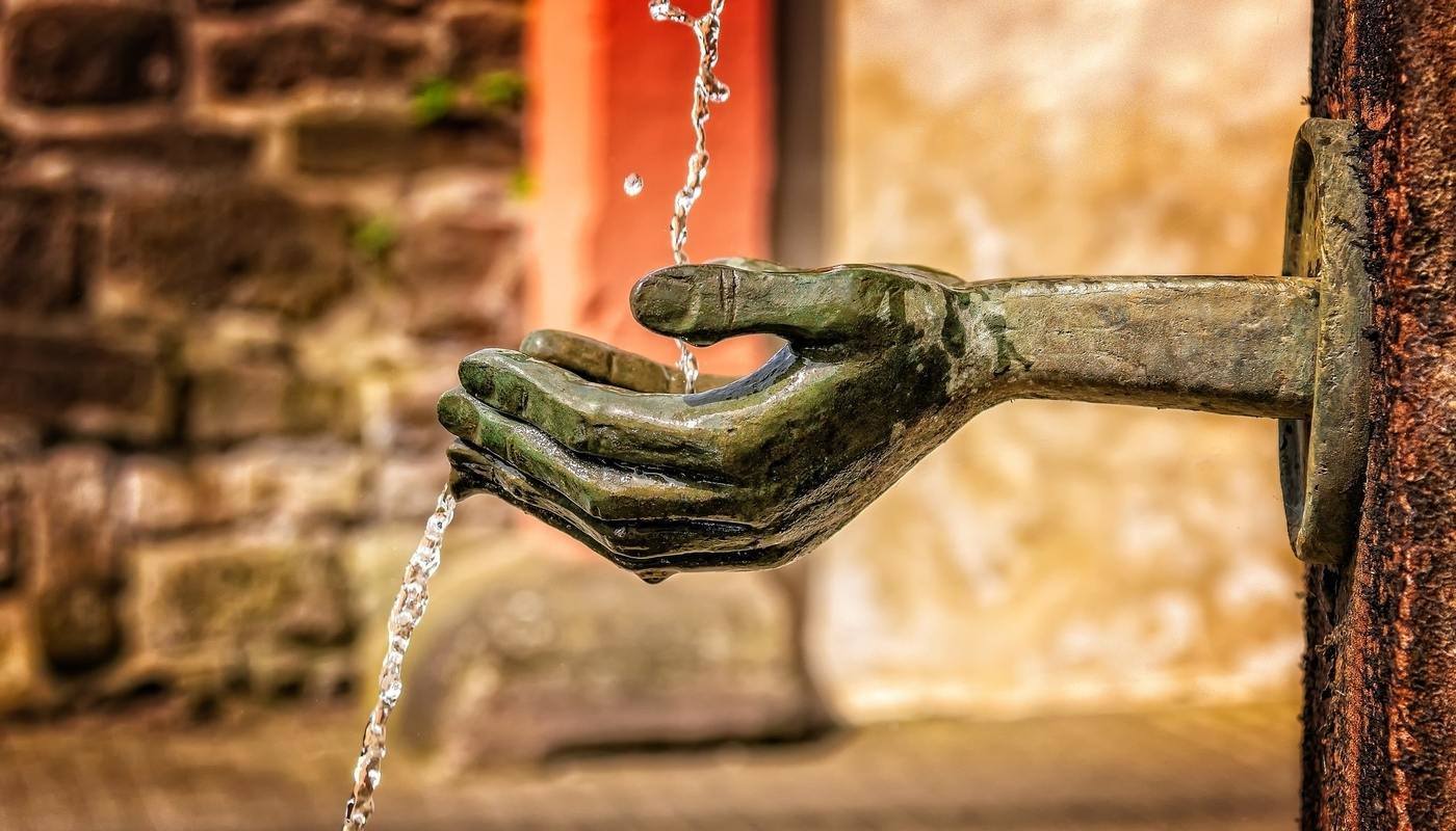 WE ARE ALL PART OF MOTHER EARTH: A spiritual vision of sustainability 15 statue hand holding water