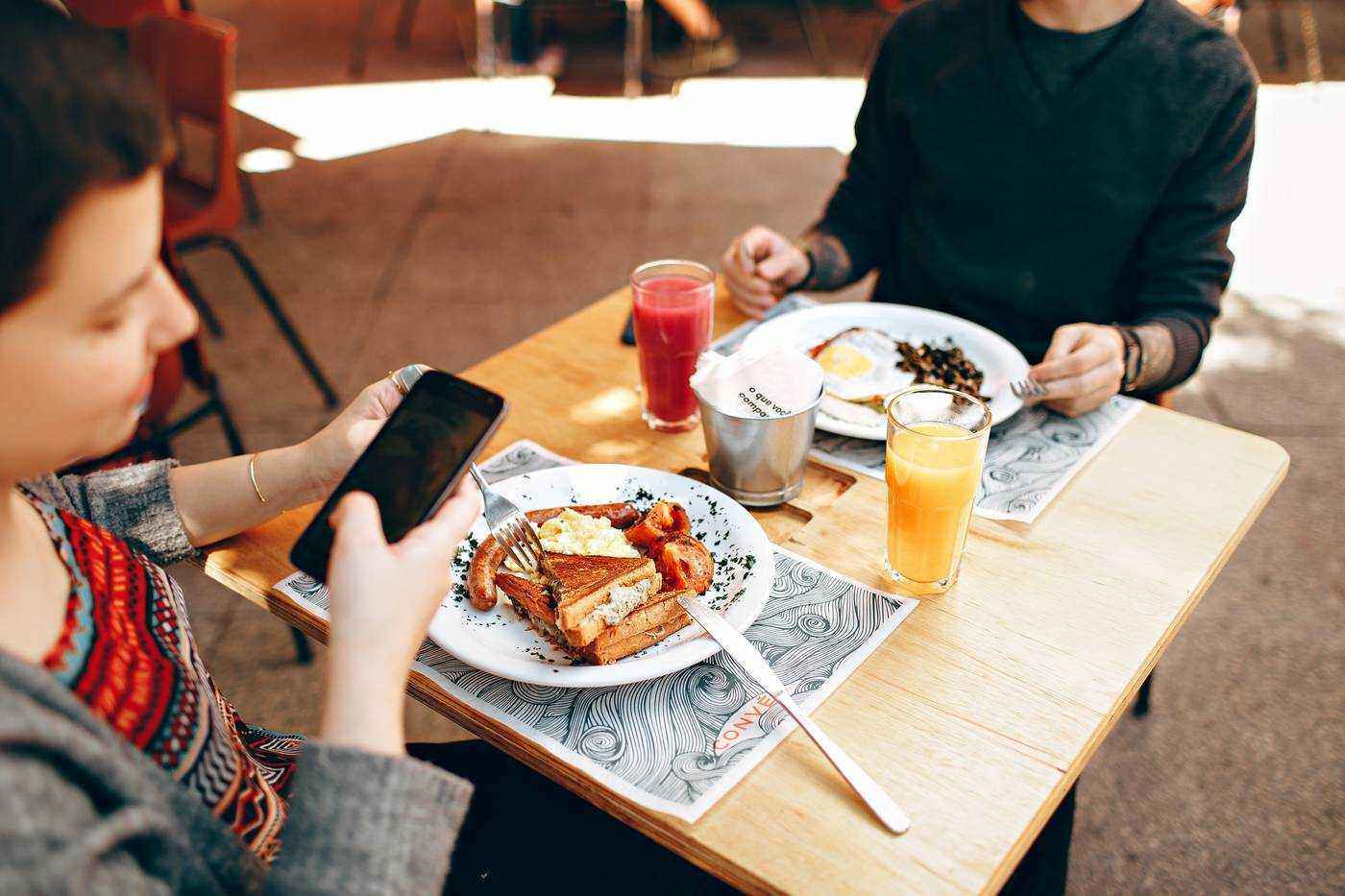 Young boy on cell phone during family brunch
