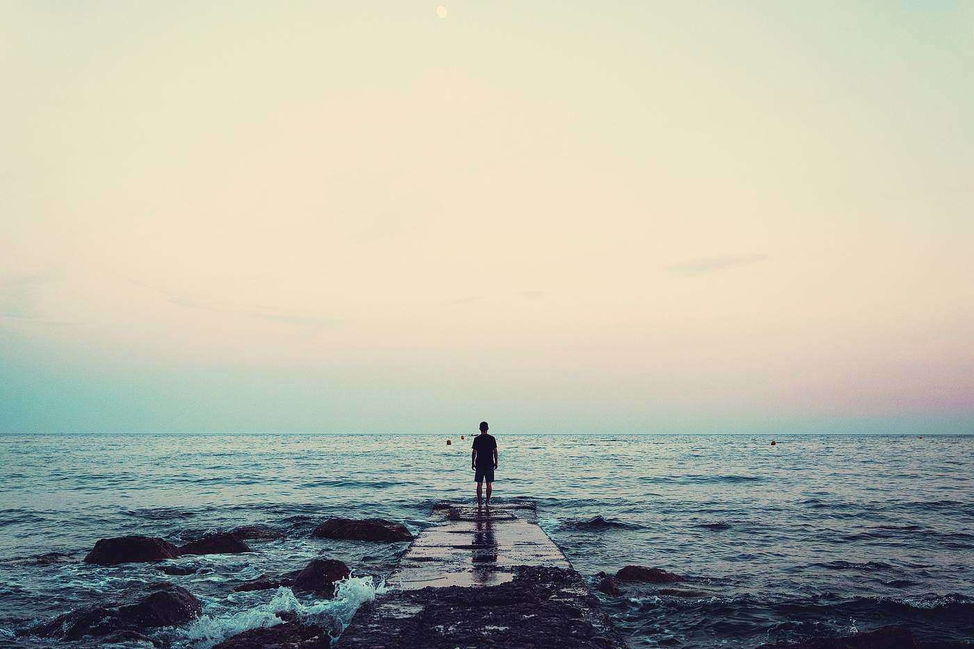Lone man next to water