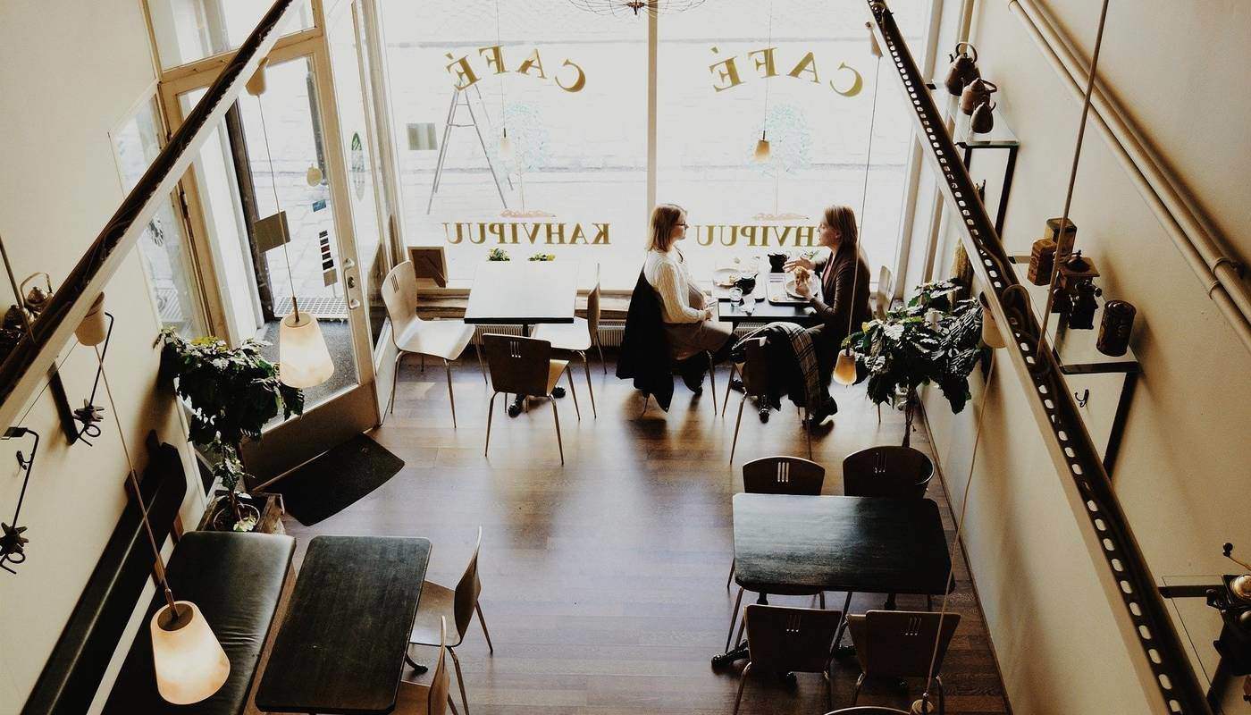 two girls sitting in a coffee shop