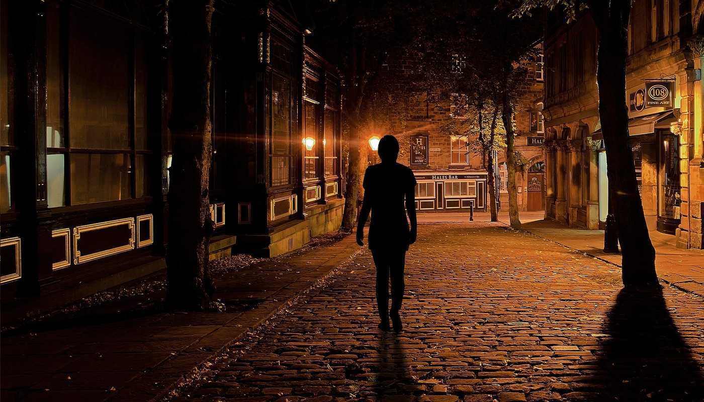 woman alone on dark street