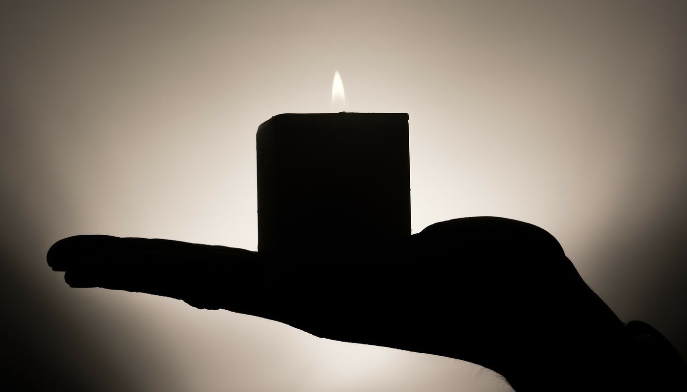 Hand holding candle