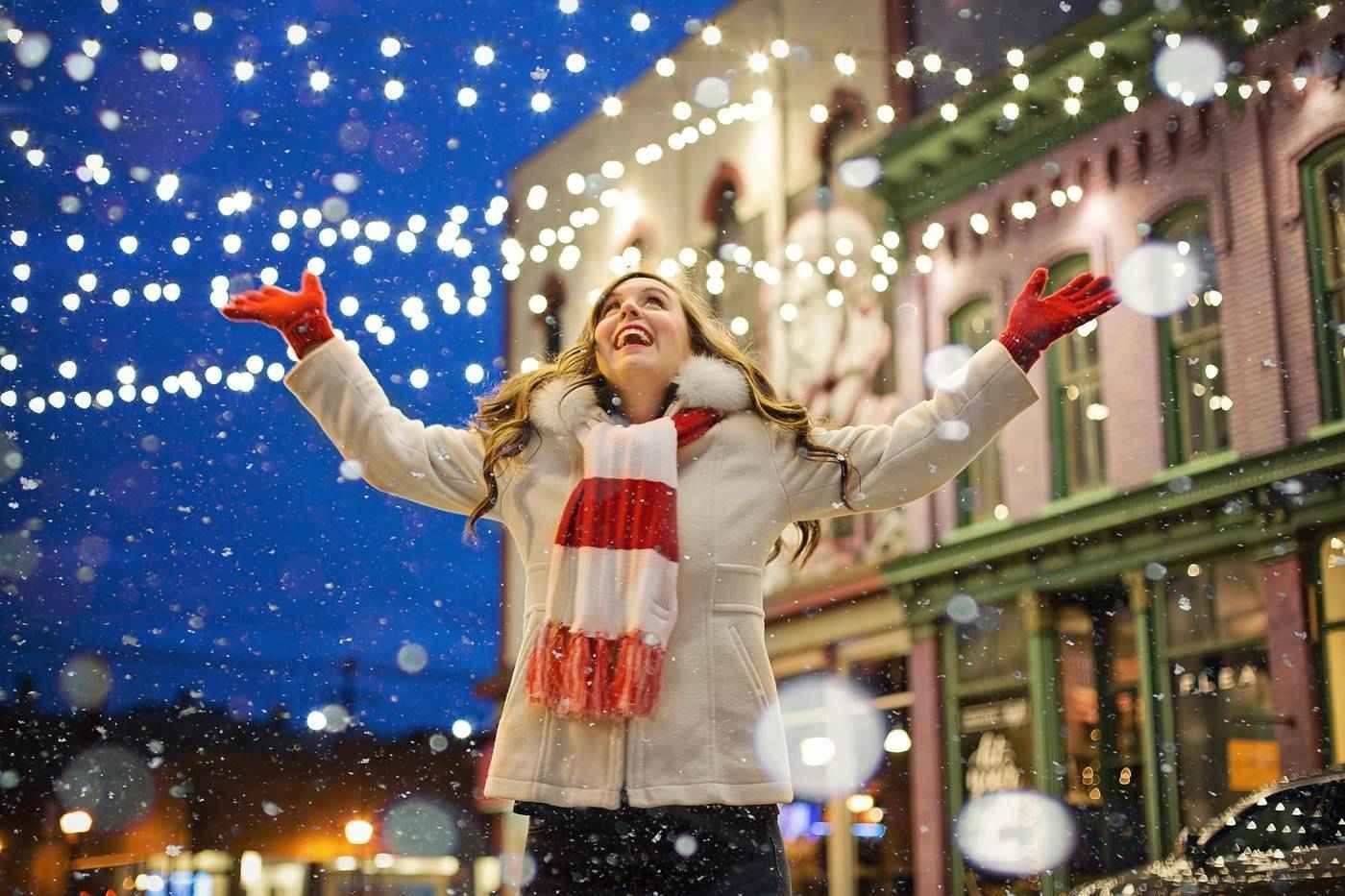Joyful woman out in snow at Christmas